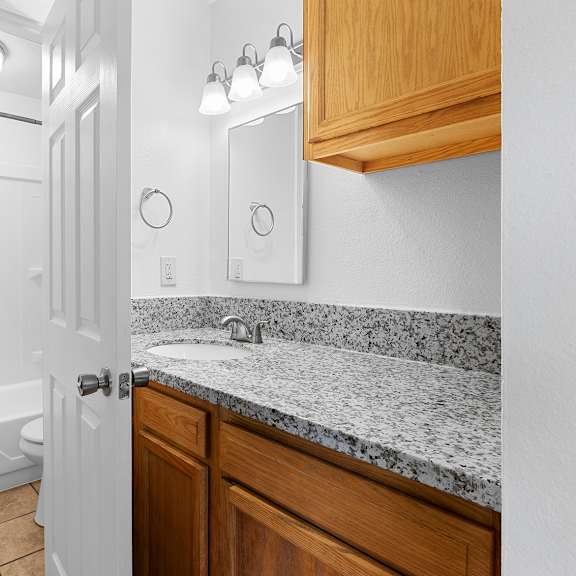 a bathroom with a white door and a marble counter top.at east wind, oregon