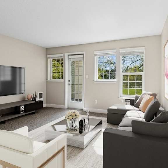 a living room with a grey couch, a white armchair, a coffee table, and a flat screen tv.