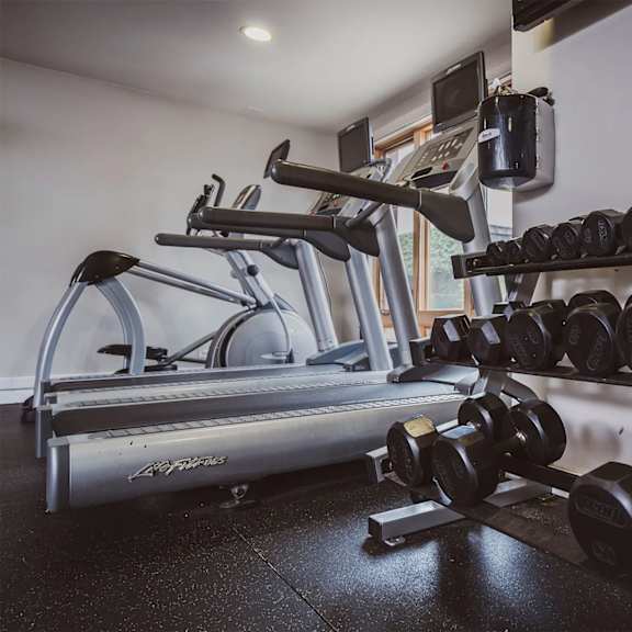 a gym with a treadmill, dumbbells and a certificate on the wall. at oak park city, illinois