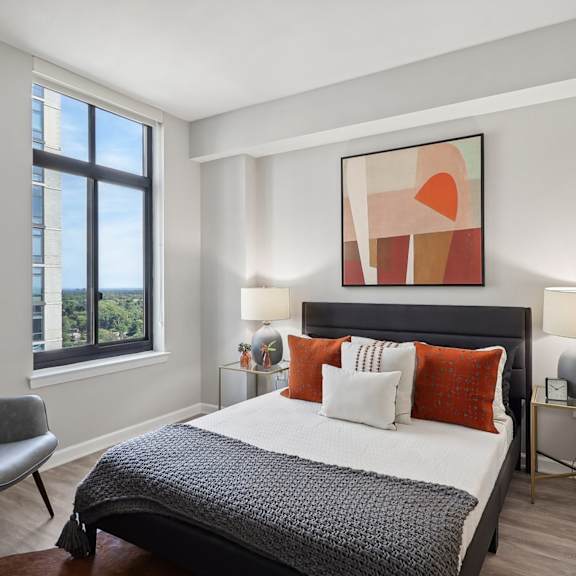 a bedroom with a bed and a large window