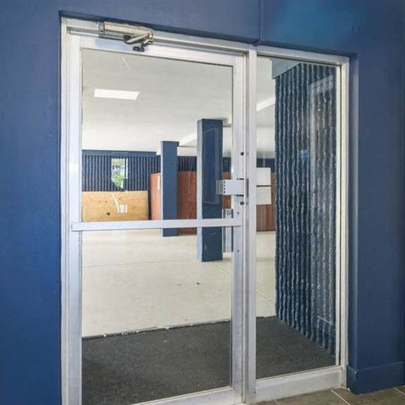 a blue room with a glass door and a blue wall at renew aurora, aurora, il, 60506