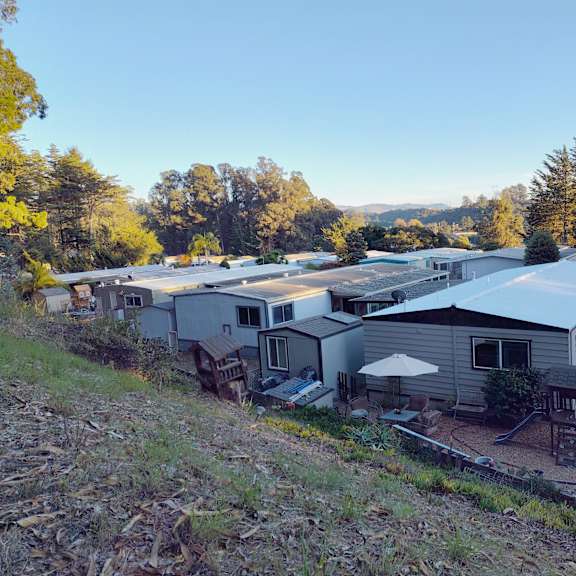 a group of houses are surrounded by trees and grass at salinas sunset apartments, salinas, ca, 93907