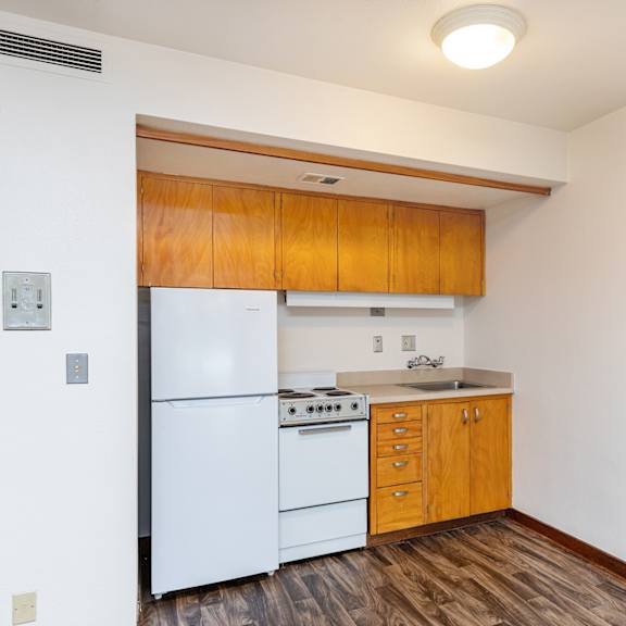 kitchen with wooden cabinets and a white refrigerator at julie ann, portland, 97215