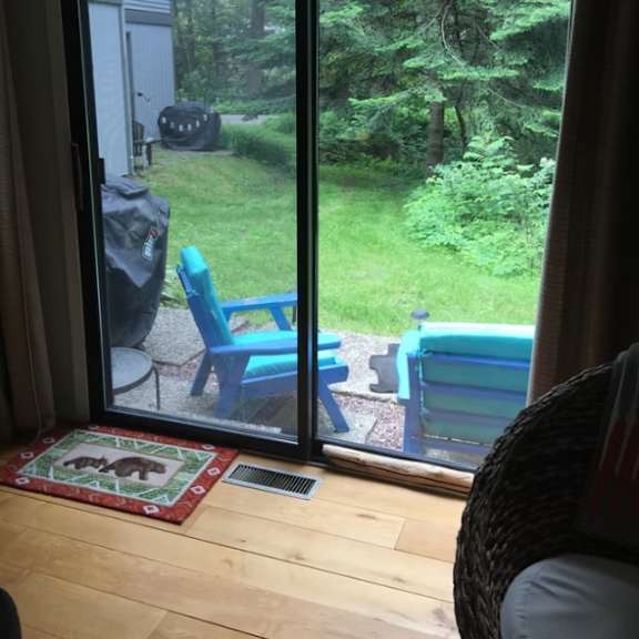 a view of a backyard from a sliding glass door at little eagle bay apartments, burlington, vt, 05408