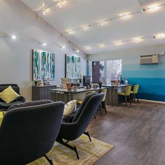 clubhouse interior with white and blue wall colors and couch at twelve 501 apartment homes, burnsville, minnesota