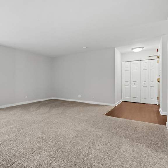 a room with a carpeted floor and white walls.