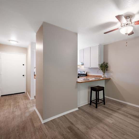 living room and kitchen with ceiling fan at oak park apartments, solvang, 93463