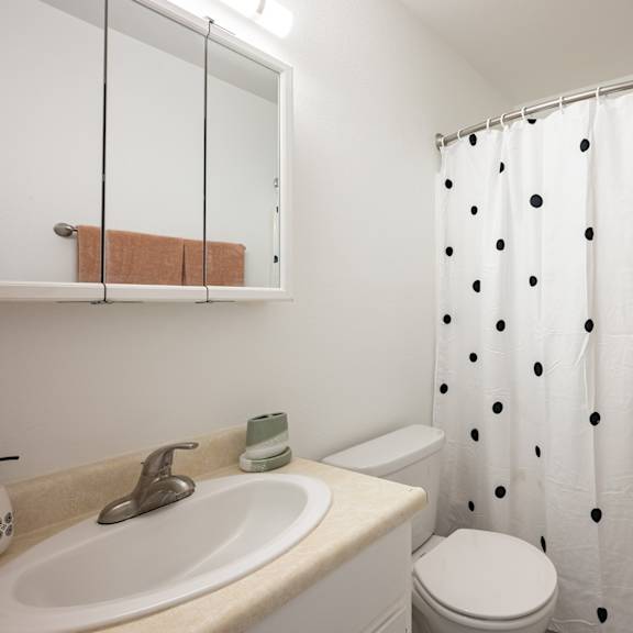 a bathroom with a shower and a sink and a toilet at oak park apartments, california