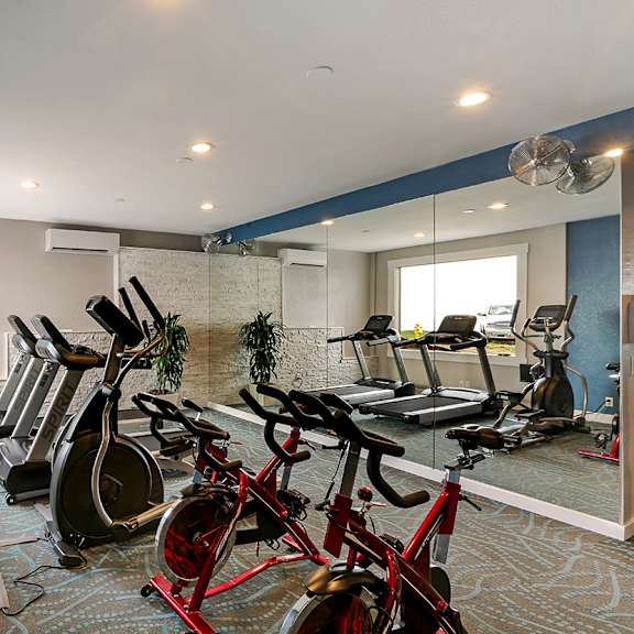 fitness center with treadmills, ellipticals and bikes  at oceanaire apartment homes, pacifica, ca