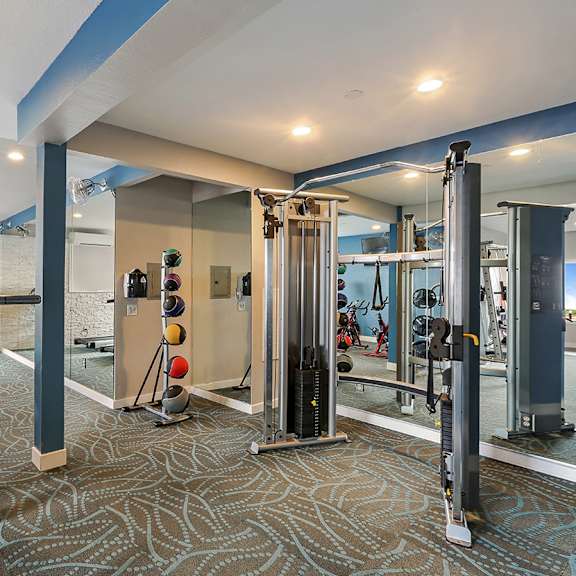 fitness center with free weights and exercise equipment  at oceanaire apartment homes, california, 94044