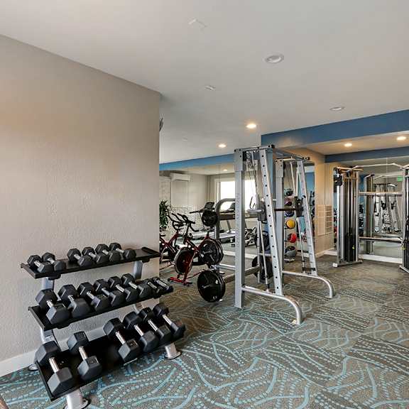 fitness center with weights  at oceanaire apartment homes, pacifica