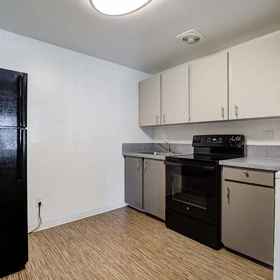 a kitchen with a stove refrigerator and dishwasher