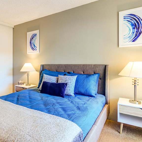 a bedroom with a bed and two night stands at the bluffs at mountain park, lake oswego