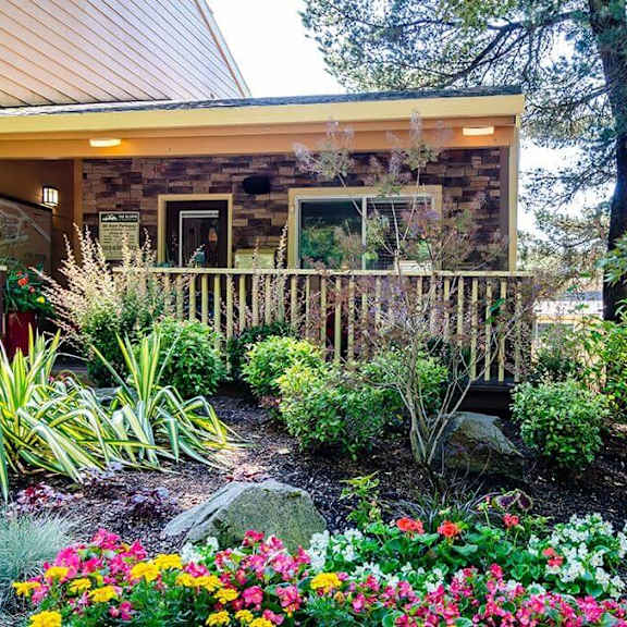 a view of the front of the house with a flower garden  at the bluffs at mountain park, lake oswego, 97035