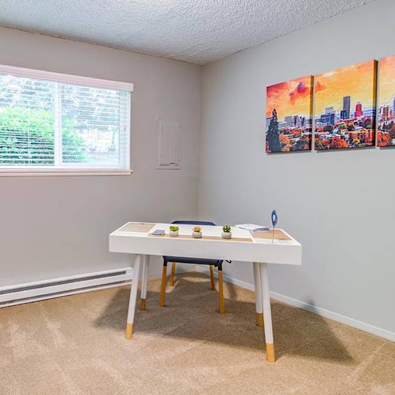 a bedroom with a bed and a desk in front of a window at the bluffs at mountain park, oregon