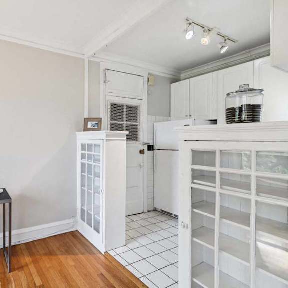 a kitchen with a white refrigerator and a door way at the bryant at oak park i & ii, illinois, 60302