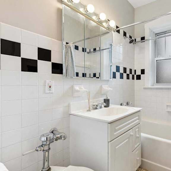 a bathroom with a sink and a mirror and a shower at the bryant at oak park i & ii, illinois