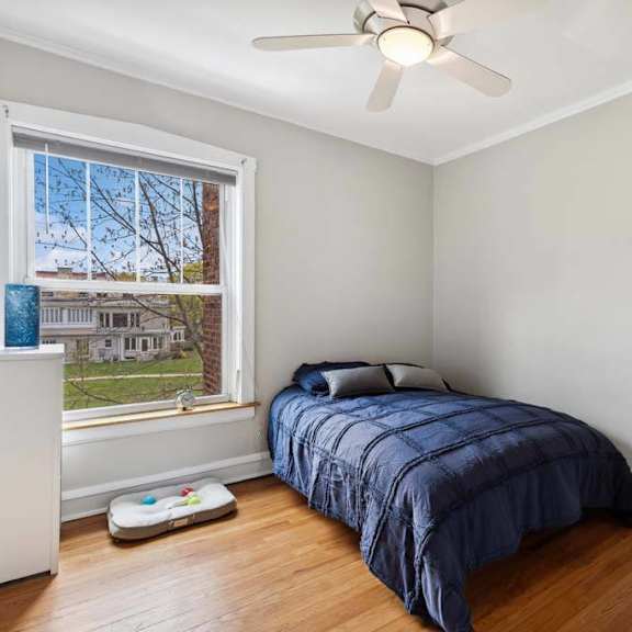a bedroom with a bed and a ceiling fan at the bryant at oak park i & ii, oak park, il