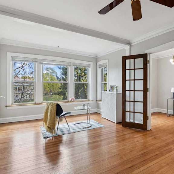 the living room has a hardwood floor and a large window at the bryant at oak park i & ii, oak park, 60302