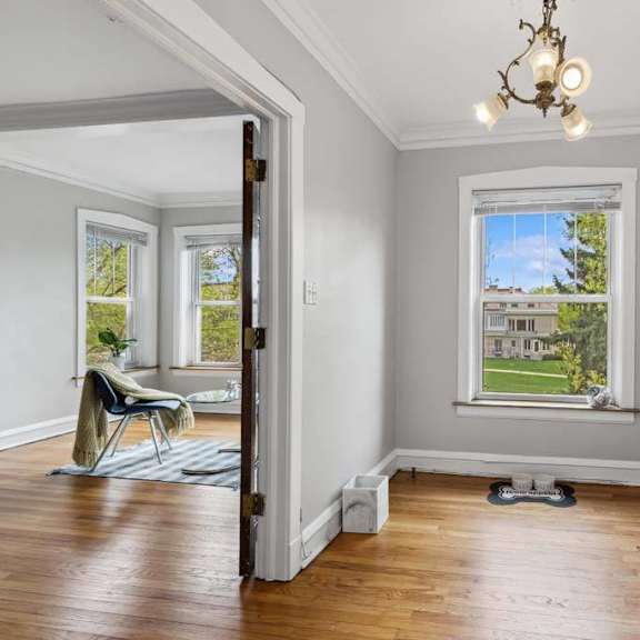 a living room with a window and a table at the bryant at oak park i & ii, oak park illinois