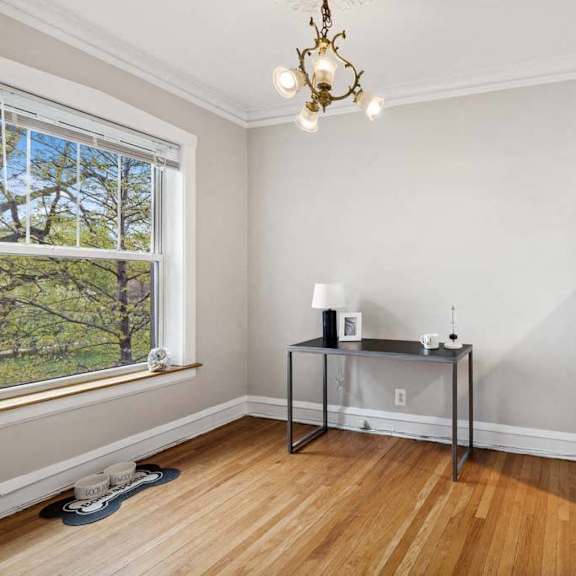an empty room with white walls and a table in the corner at the bryant at oak park i & ii, oak park, il