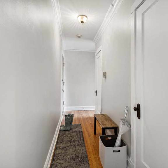 a hallway with white walls and a wooden floor at the bryant at oak park i & ii, oak park illinois