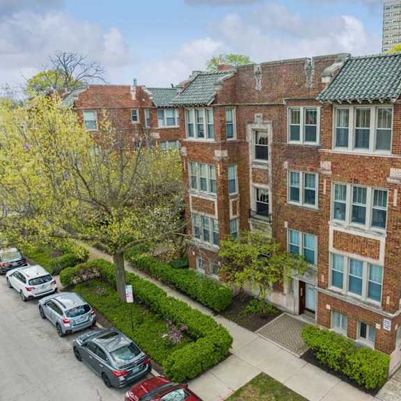 an aerial view of a brick apartment building with a parking lot at the bryant at oak park i & ii, illinois, 60302