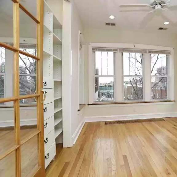 an empty living room with a closet and a window at the bryant at oak park i & ii, illinois, 60302