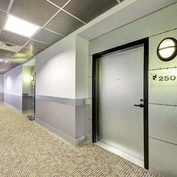 a hallway with a door and a clock on the wall at flats at southside, pittsburgh, pa