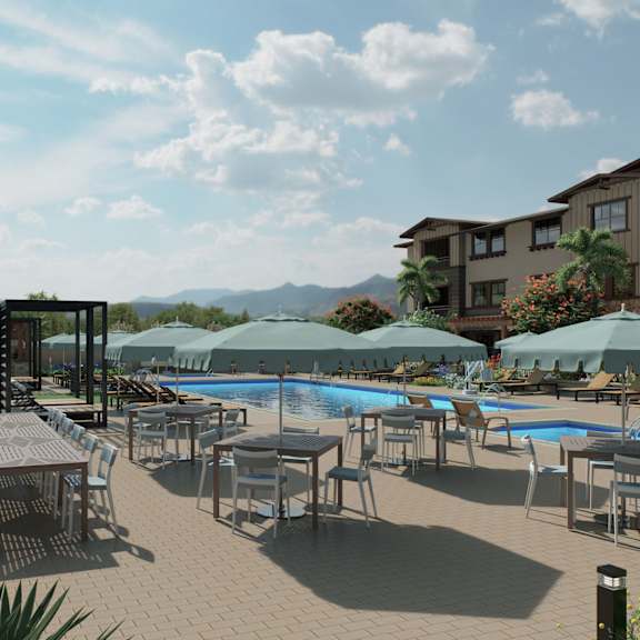 a poolside area with tables and chairs and umbrellas.