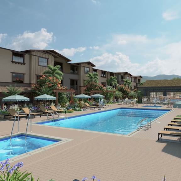 a large swimming pool surrounded by lounge chairs and umbrellas.