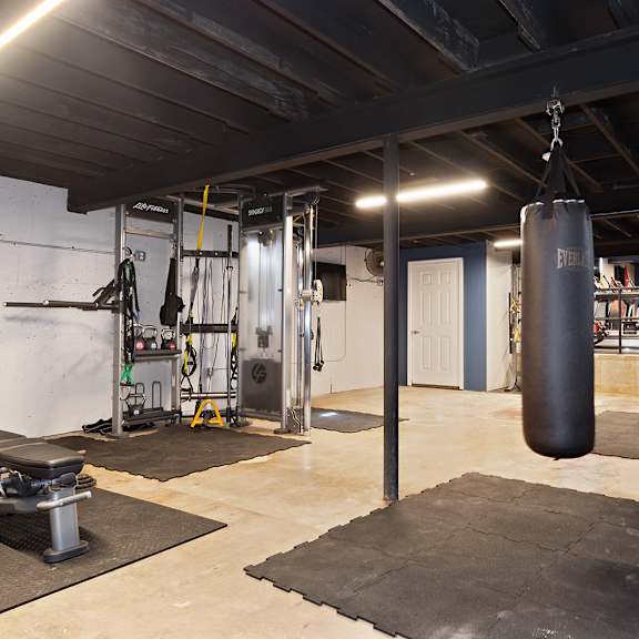 a gym with a punching bag hanging from the ceiling.