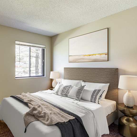 a bedroom with a large bed and two framed pictures on the wall.