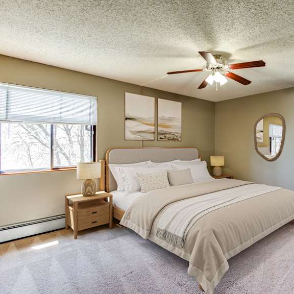 a bedroom with a large bed and a ceiling fan.