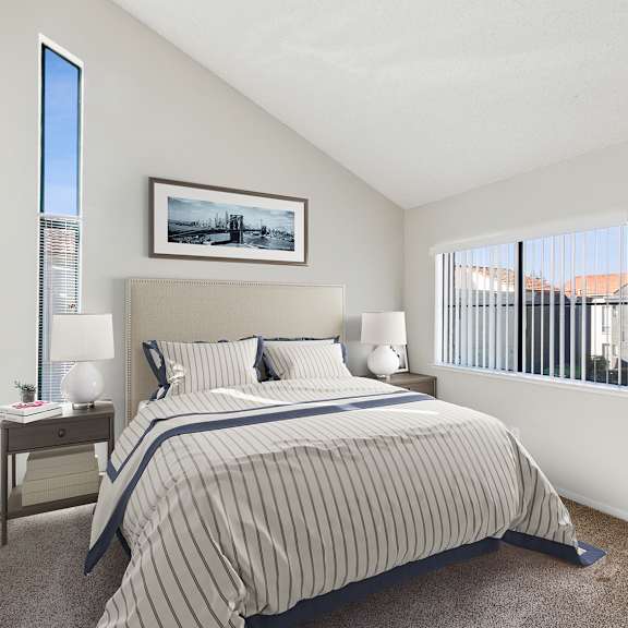 a bedroom with a bed, nightstand, and a painting on the wall.