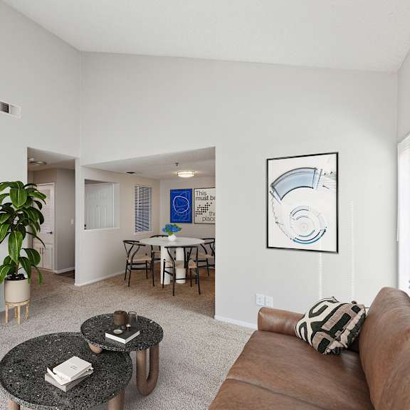 a living room with a brown couch, a coffee table, and a flat screen tv.