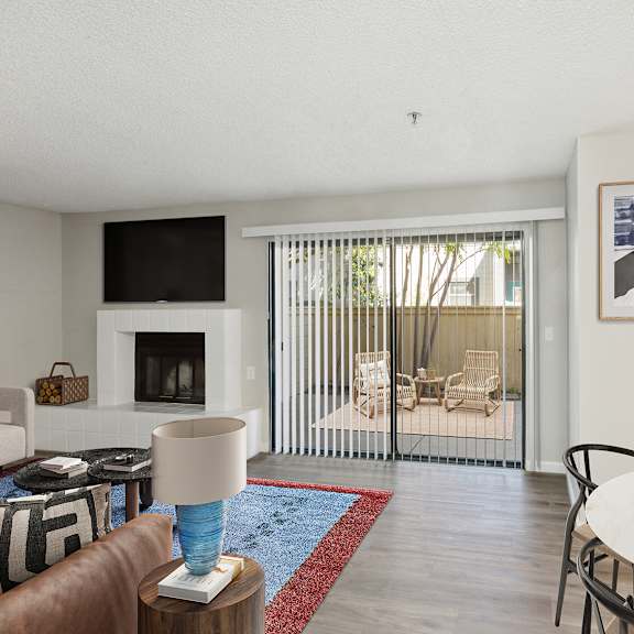 a living room with a white couch and a fireplace.
