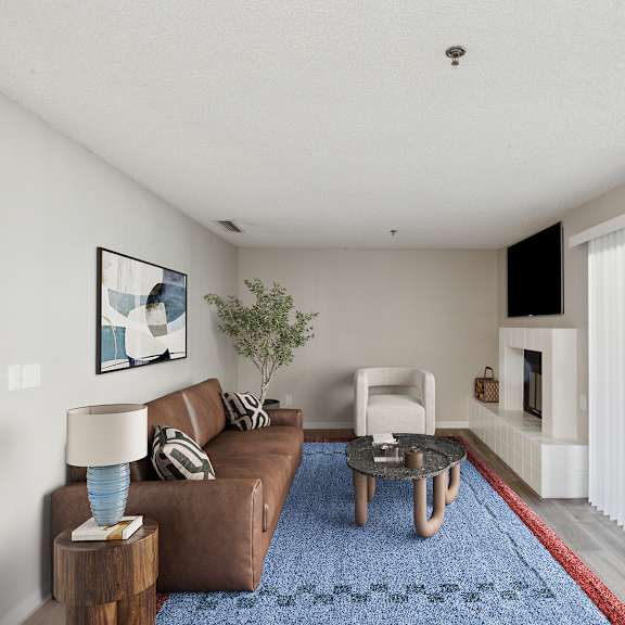 a living room with a brown couch, a blue rug, and a painting on the wall.