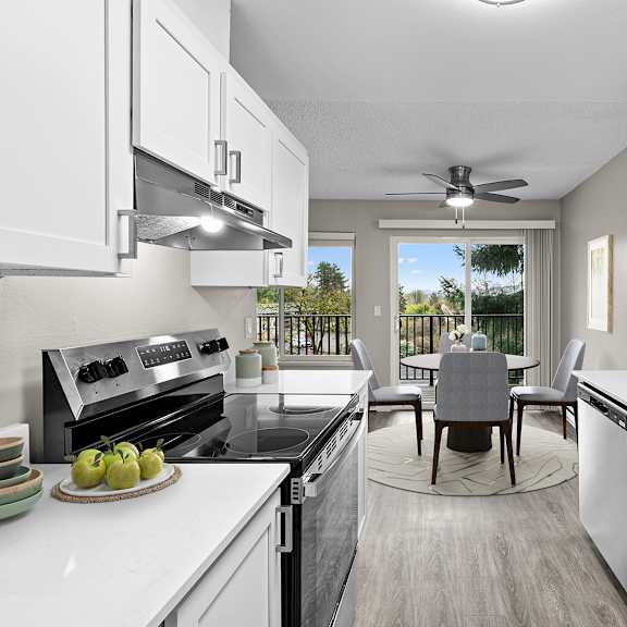 a modern kitchen with a dining table and chairs in the middle.
