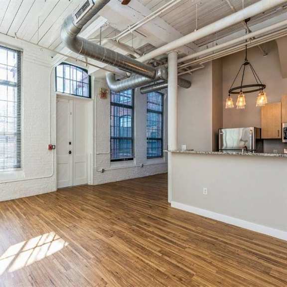 room with wooden flooring and kitchen at rising sun mills, providence, rhode island