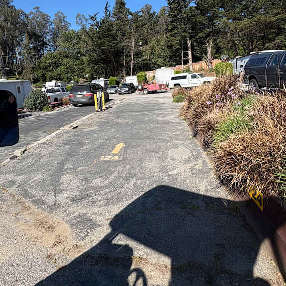 a white car is parked on the side of a road.