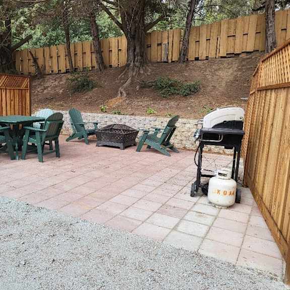 a patio with a table and chairs and a gas grill at salinas sunset apartments, salinas, california