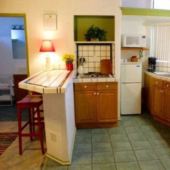 a kitchen with a white fridge at salinas sunset apartments, california