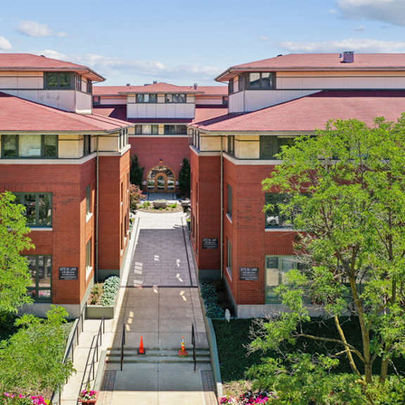 a red brick building with a walkway in front.