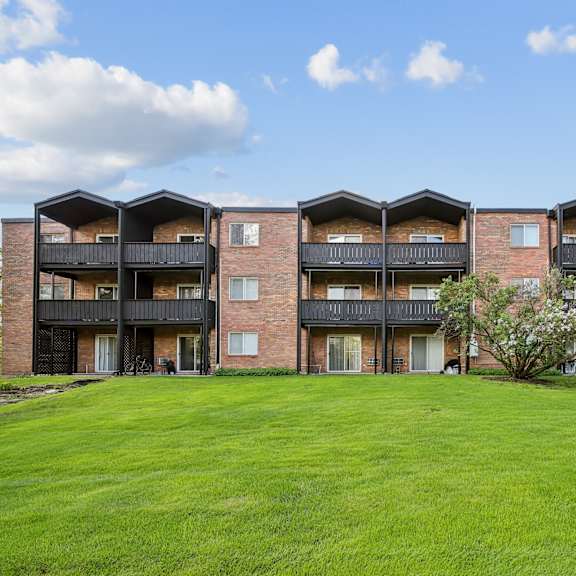 a large grassy area in front of apartment buildings.