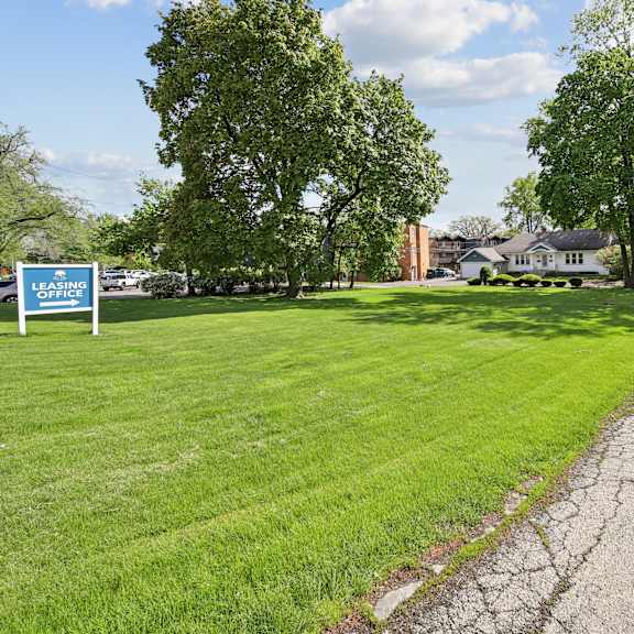 grass with a leasing office sign