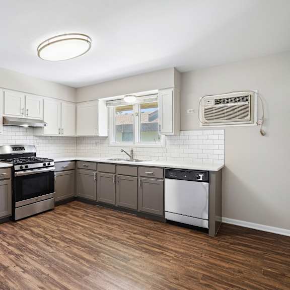 a kitchen with a refrigerator, stove, and dishwasher.