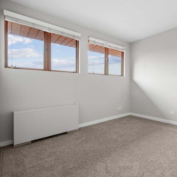 a room with a window and a radiator on the wall.