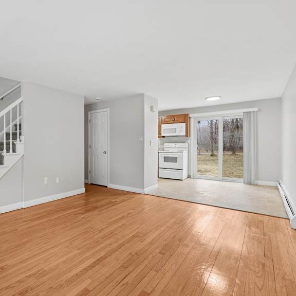 a room with wooden floors and a staircase.