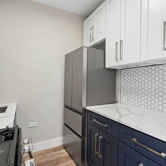 a kitchen with a black stove top oven and a white counter top.